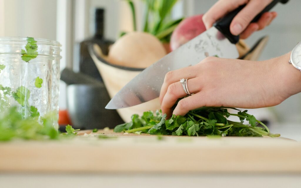 Fresh vegetables being chopped on a kitchen worktop